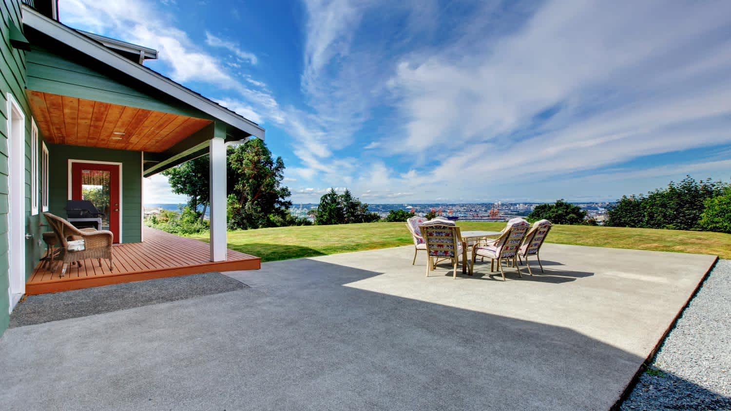 View of large concrete floor patio area at backyard