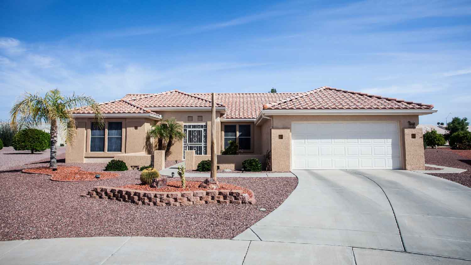 The exterior of a house with cacti in its front yard