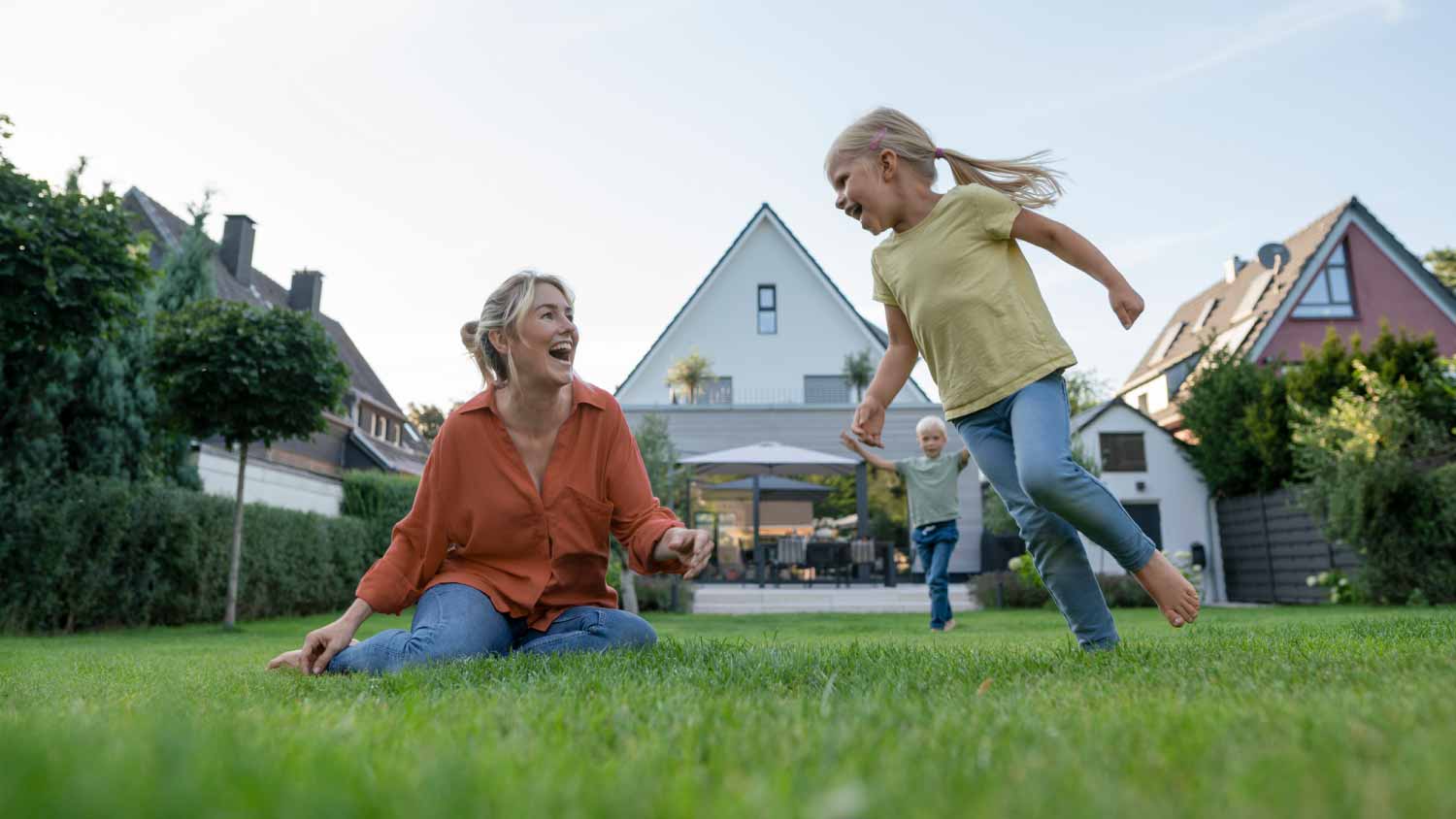 Woman with daughter and son enjoying in backyard