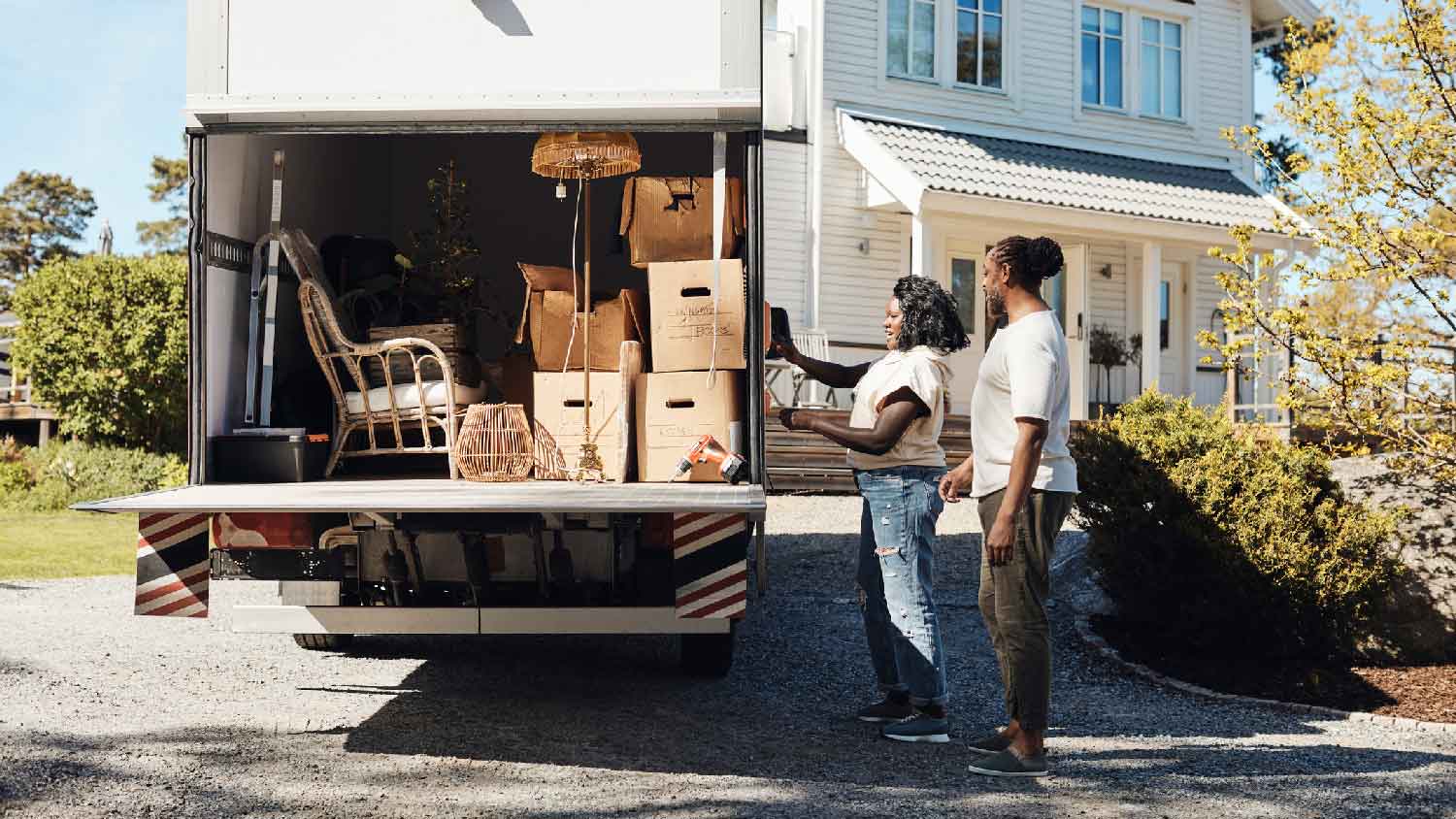 A couple closing truck door on moving day