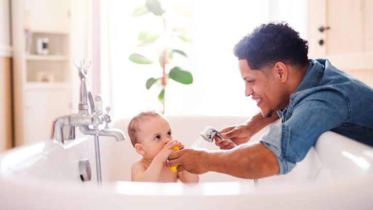Father giving son a bath