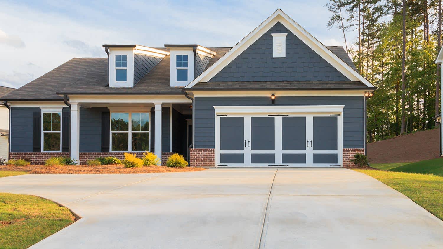 Small blue house with nice concrete driveway