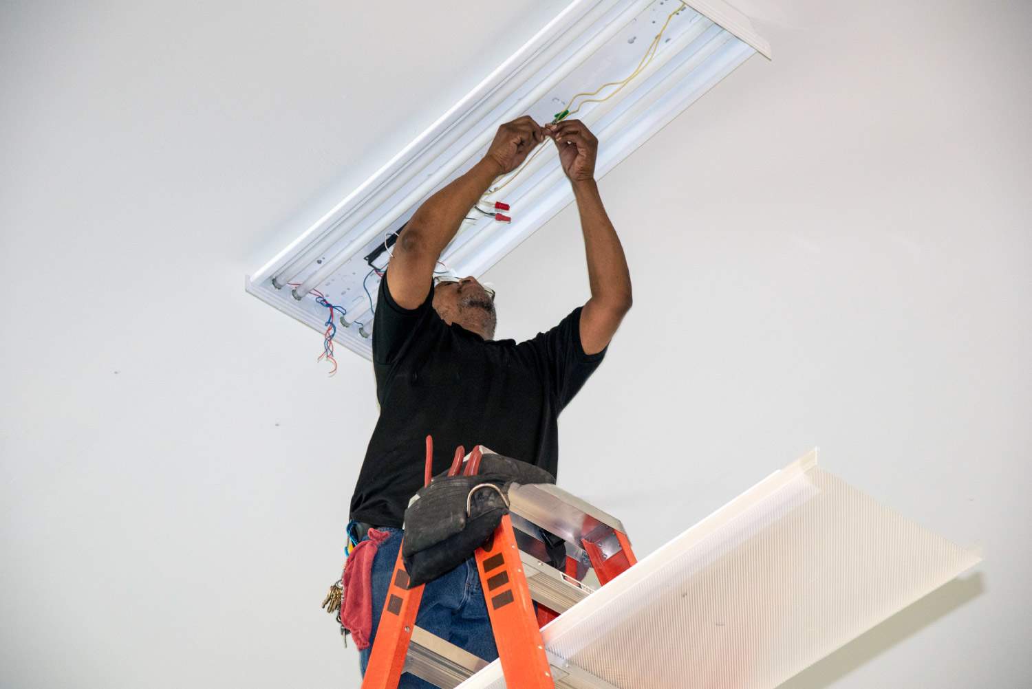 An electrician installing new lights