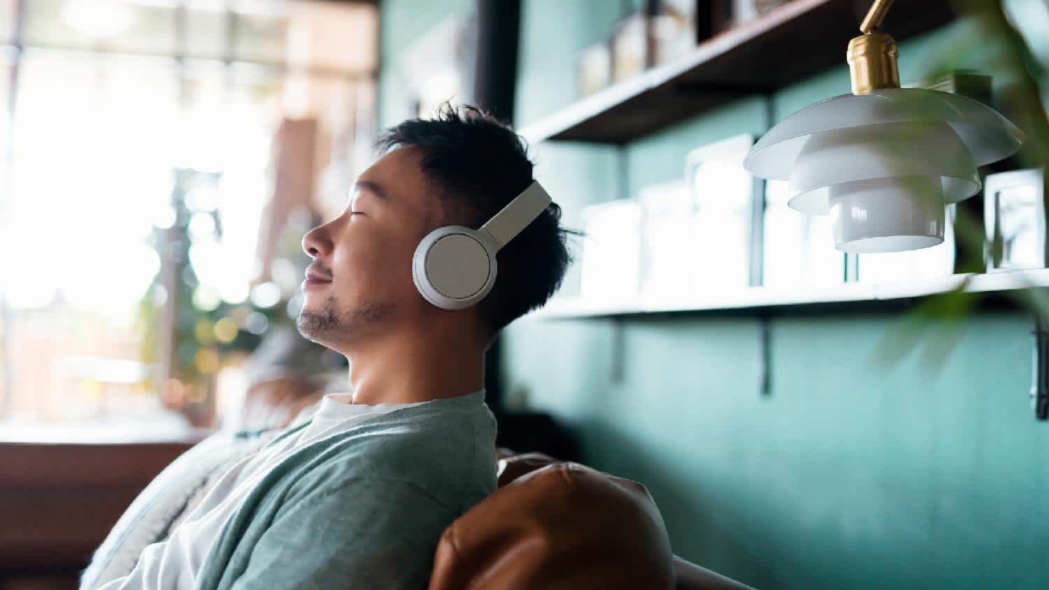 A man relaxing in his living room while listening to music