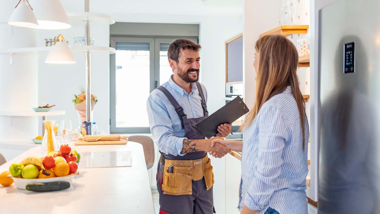 A contractor shaking hands with home owner