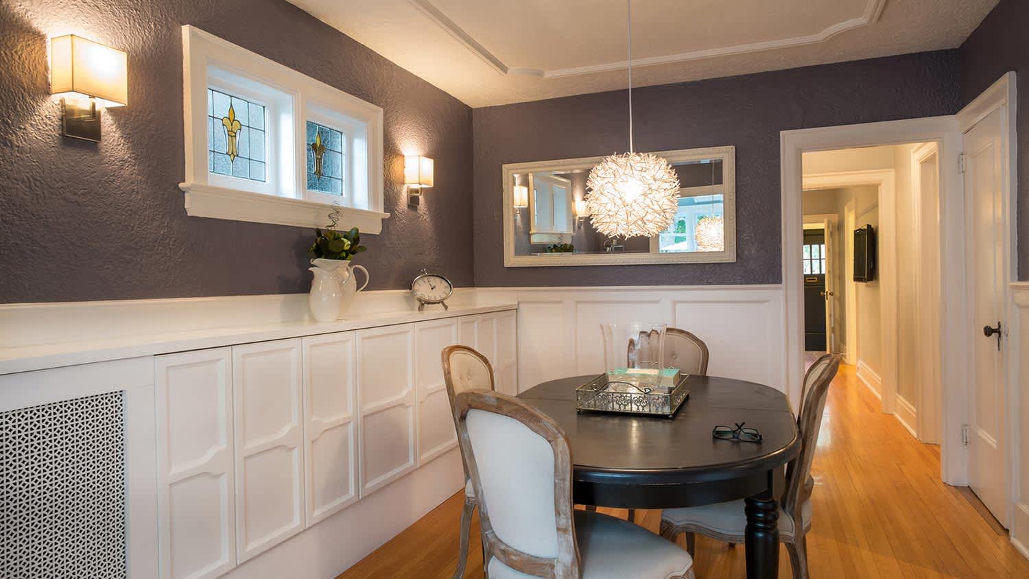 Rough plaster walls painted dark grey in dining room