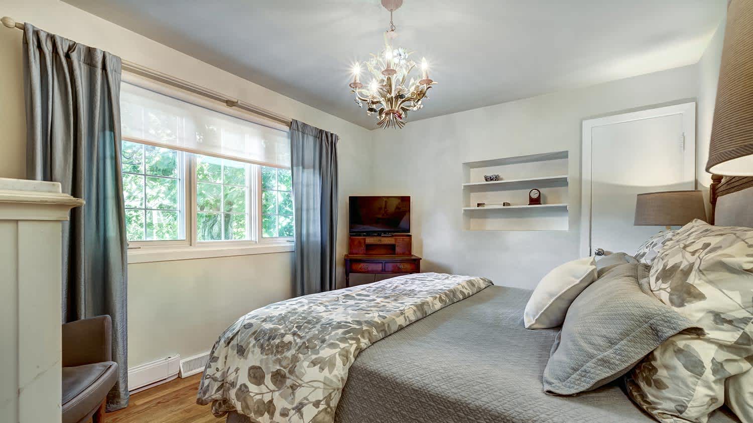 Pretty bedroom with light-filtering blinds and curtains