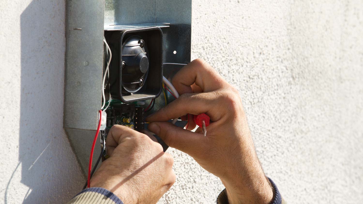 An electrician maintaining a HVAC surge protector