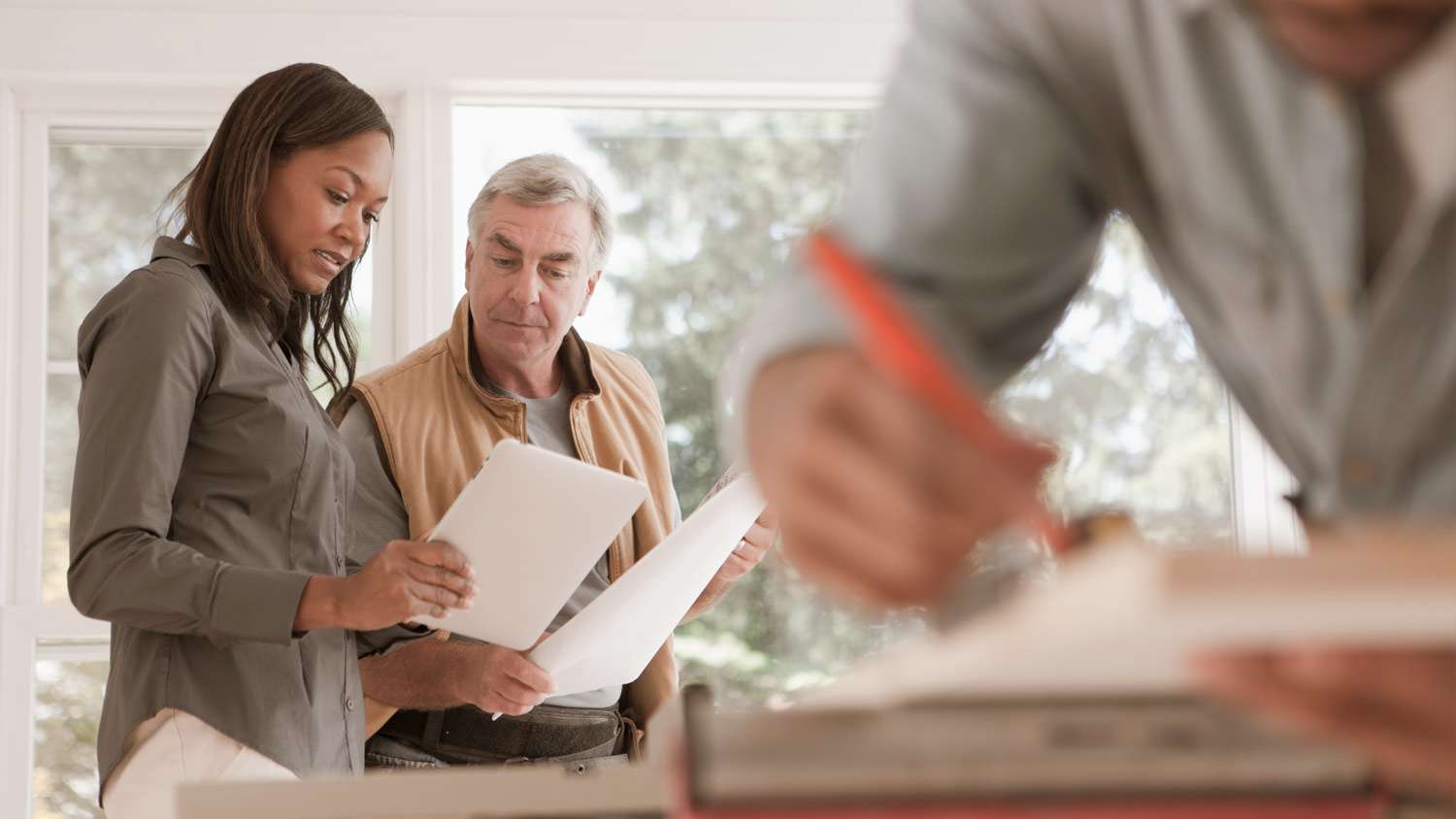 A woman checks the home project with contractor