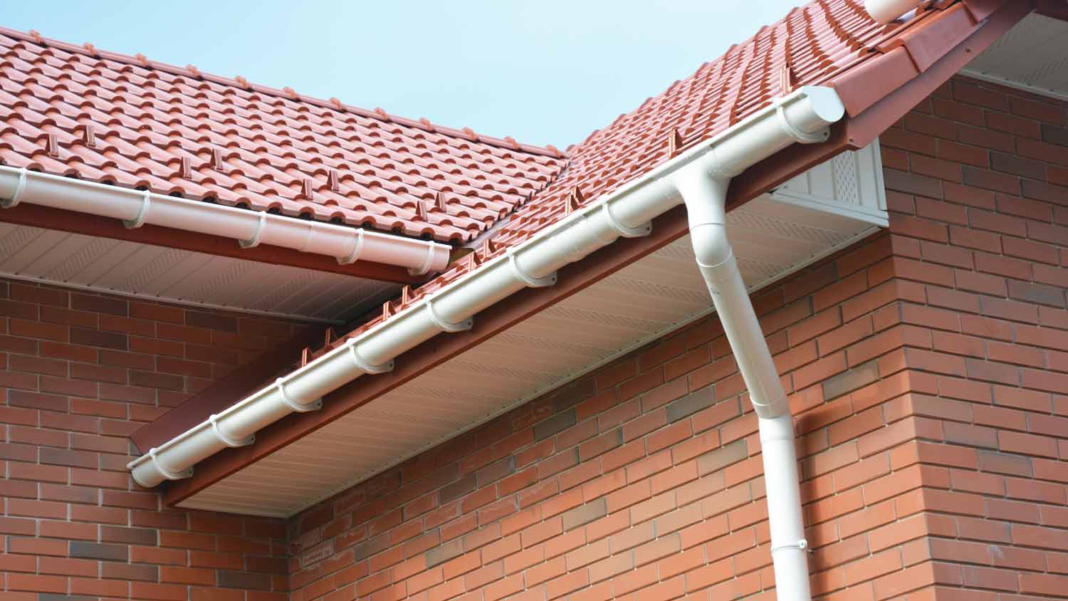 brick house with rain gutter pipe system