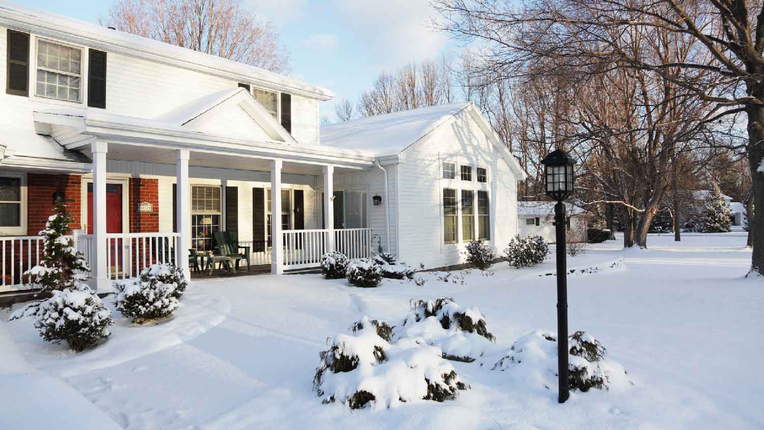 A house in the suburbs covered in snow during the winter