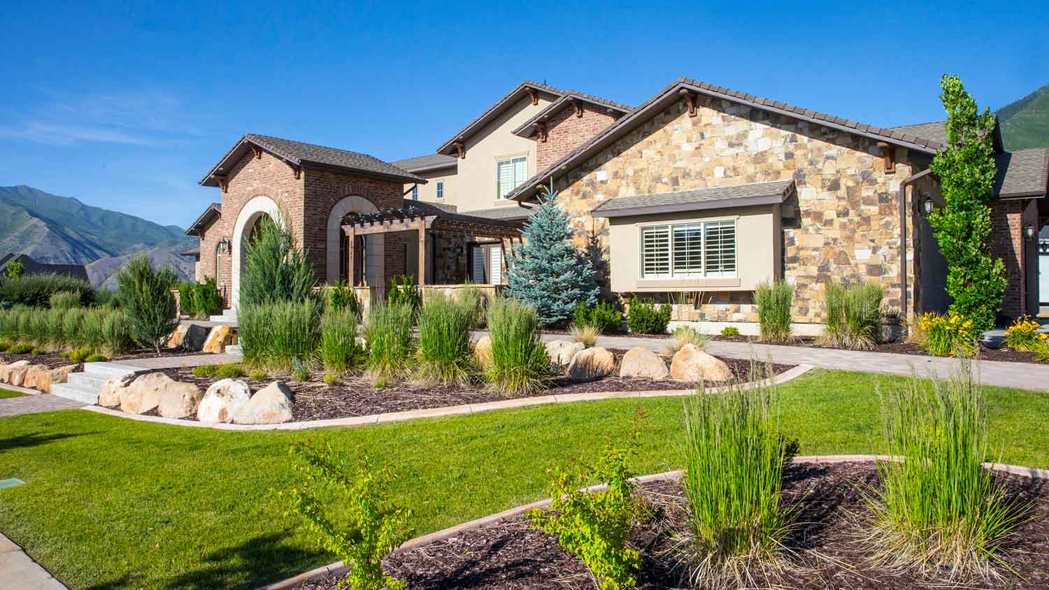 Large house exterior with landscaped yard