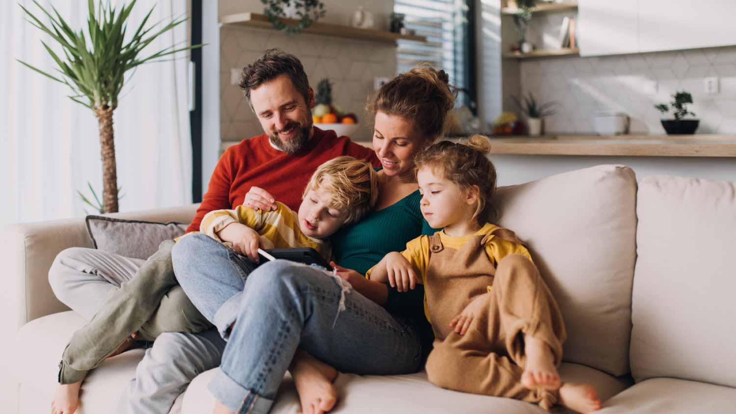 Parents and children on sofa at home