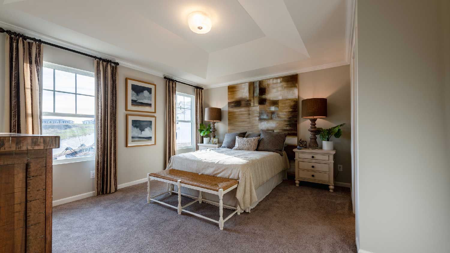 A bedroom with a gray carpet
