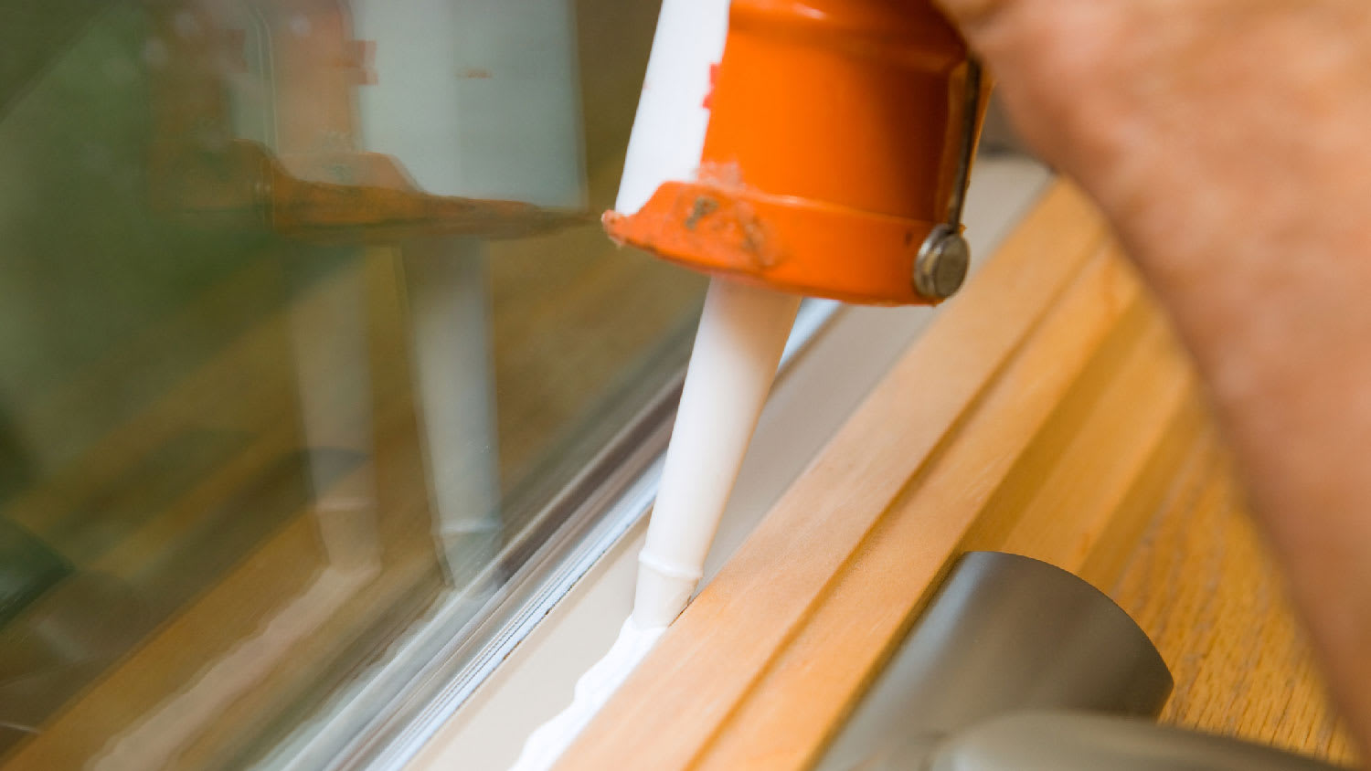 Close-up of caulking a window