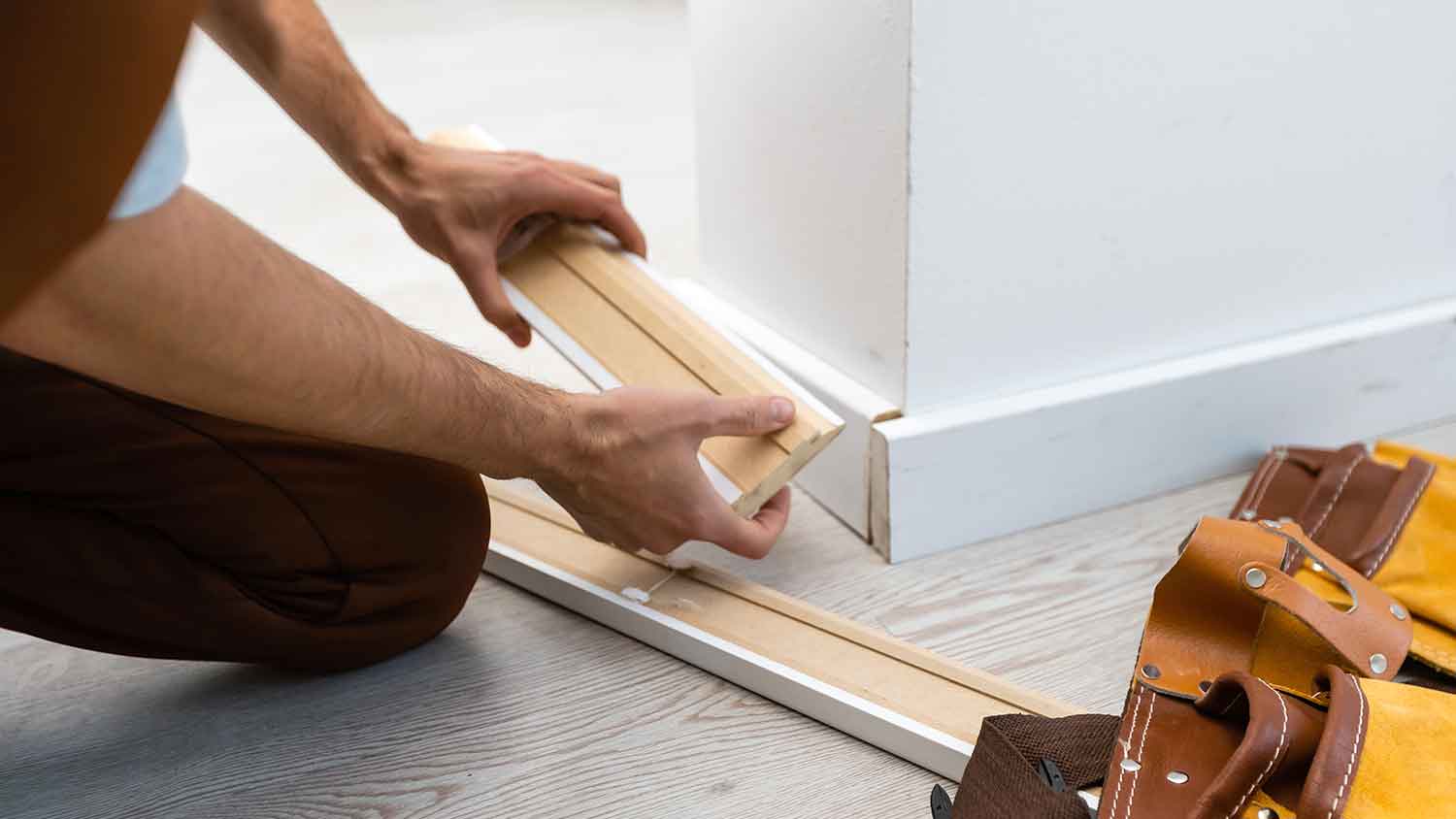 Man installing MDF baseboard