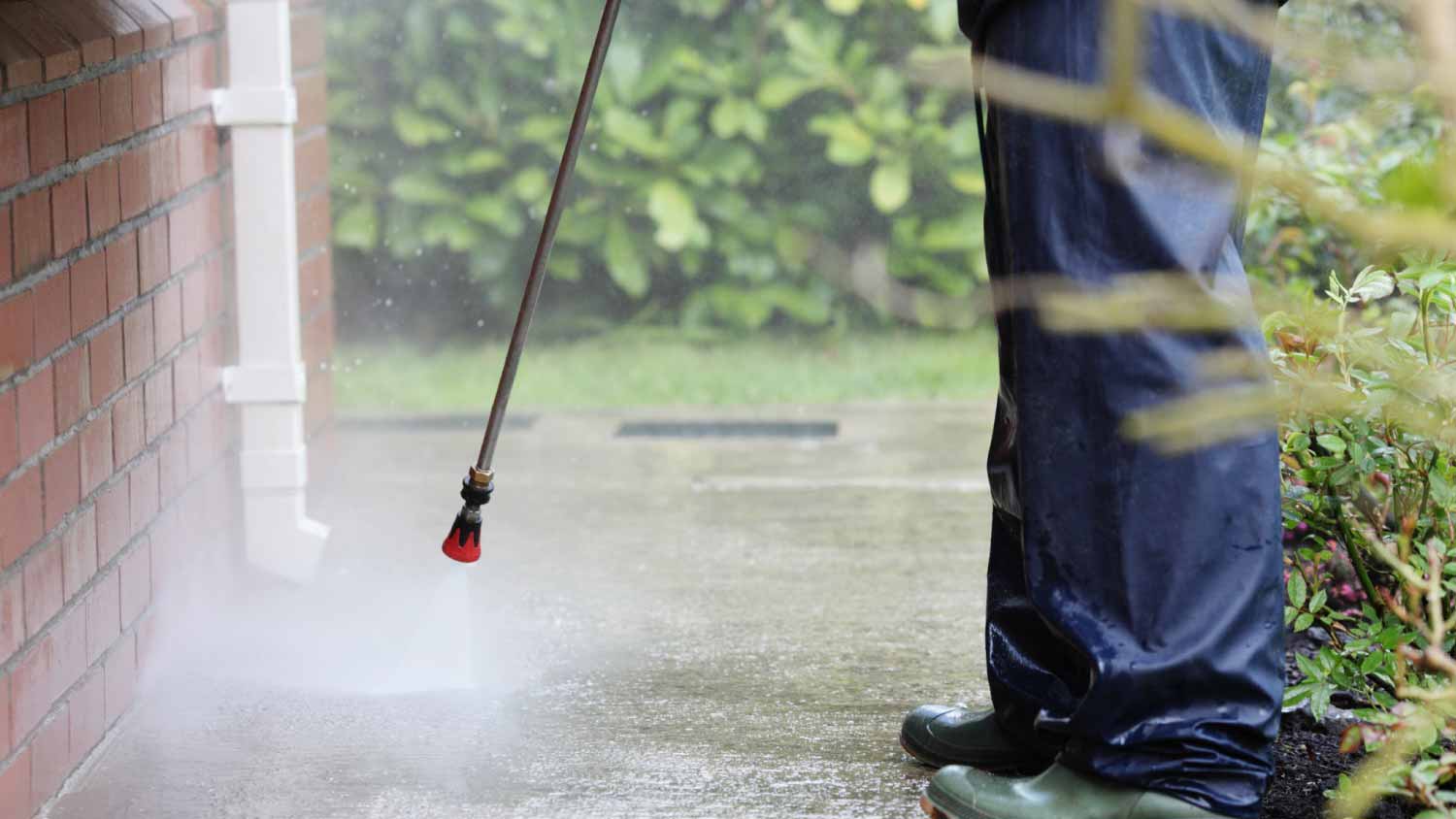 Man cleaning path with power pressure system