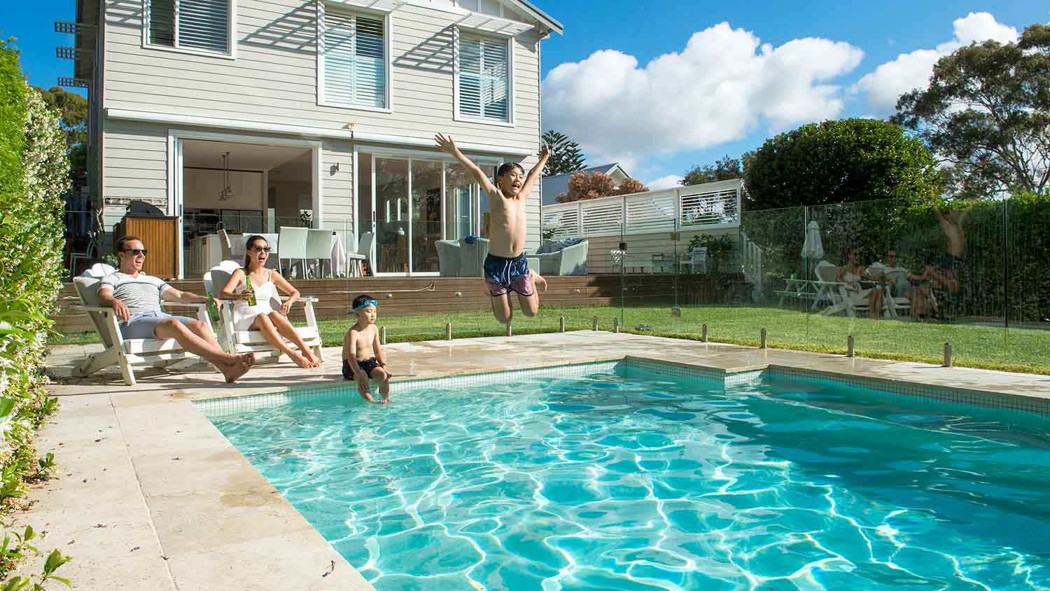 Family enjoying backyard pool