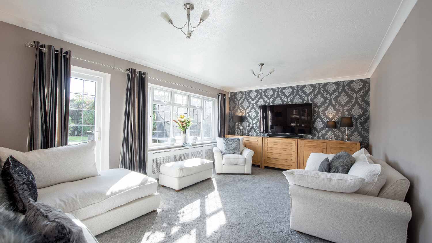 A cozy living room with wallpaper on one wall