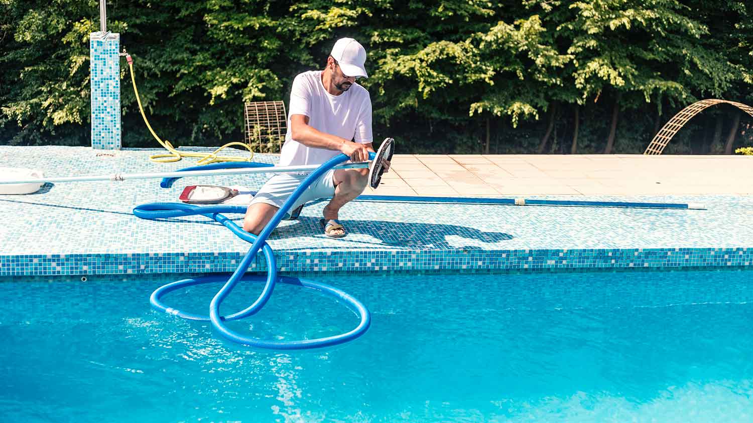 Homeowner getting ready to clean swimming pool
