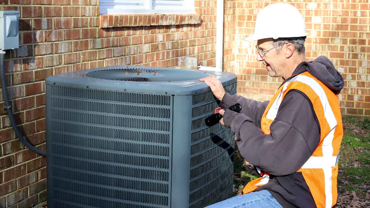 A professional maintaining a HVAC unit