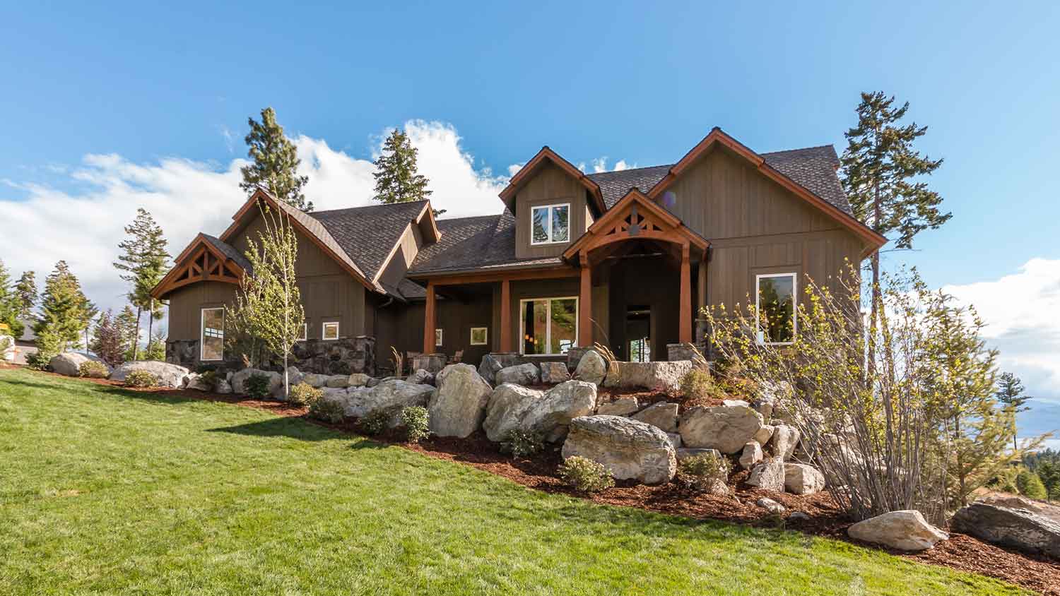 Large house with boulder landscaped yard