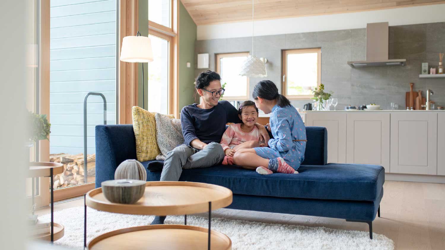 A family of three lounging in the living room