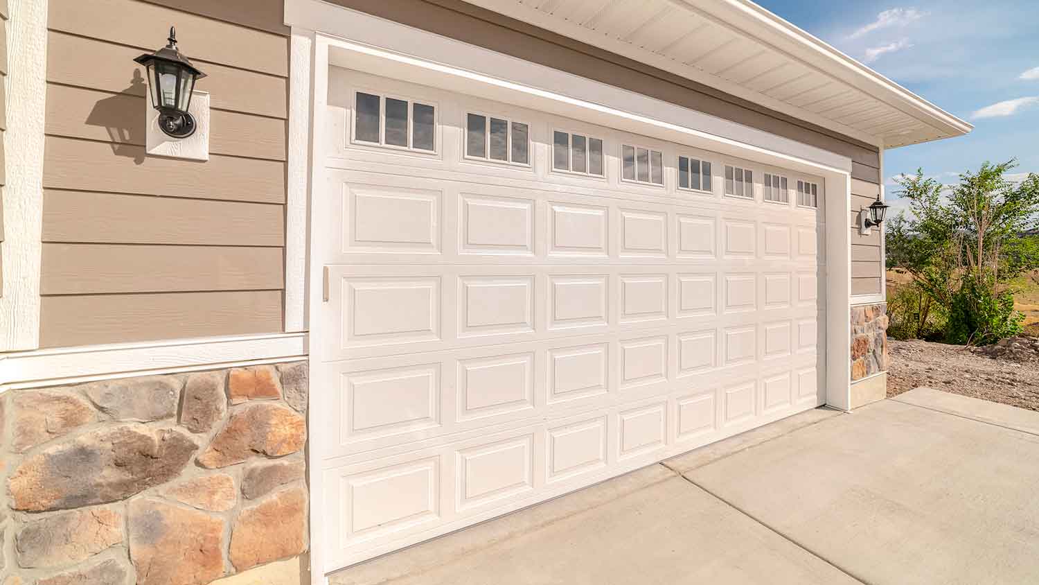 Residential garage door with white frame