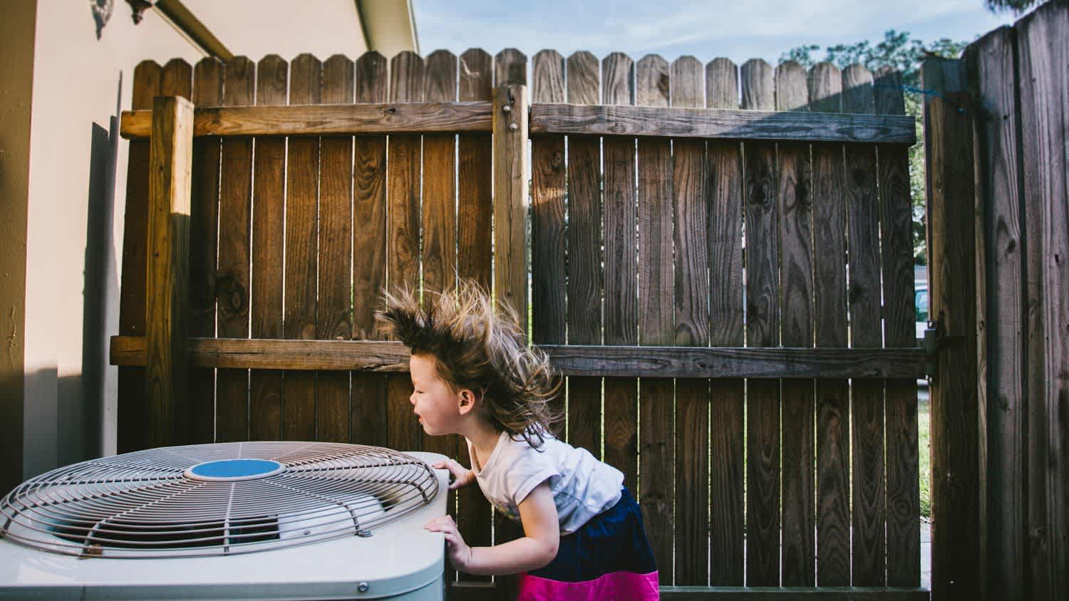 Girls hair blowing by ac unit