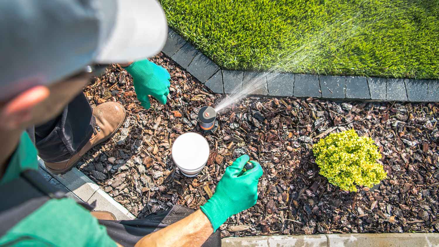Technician adjusting lawn irrigation system