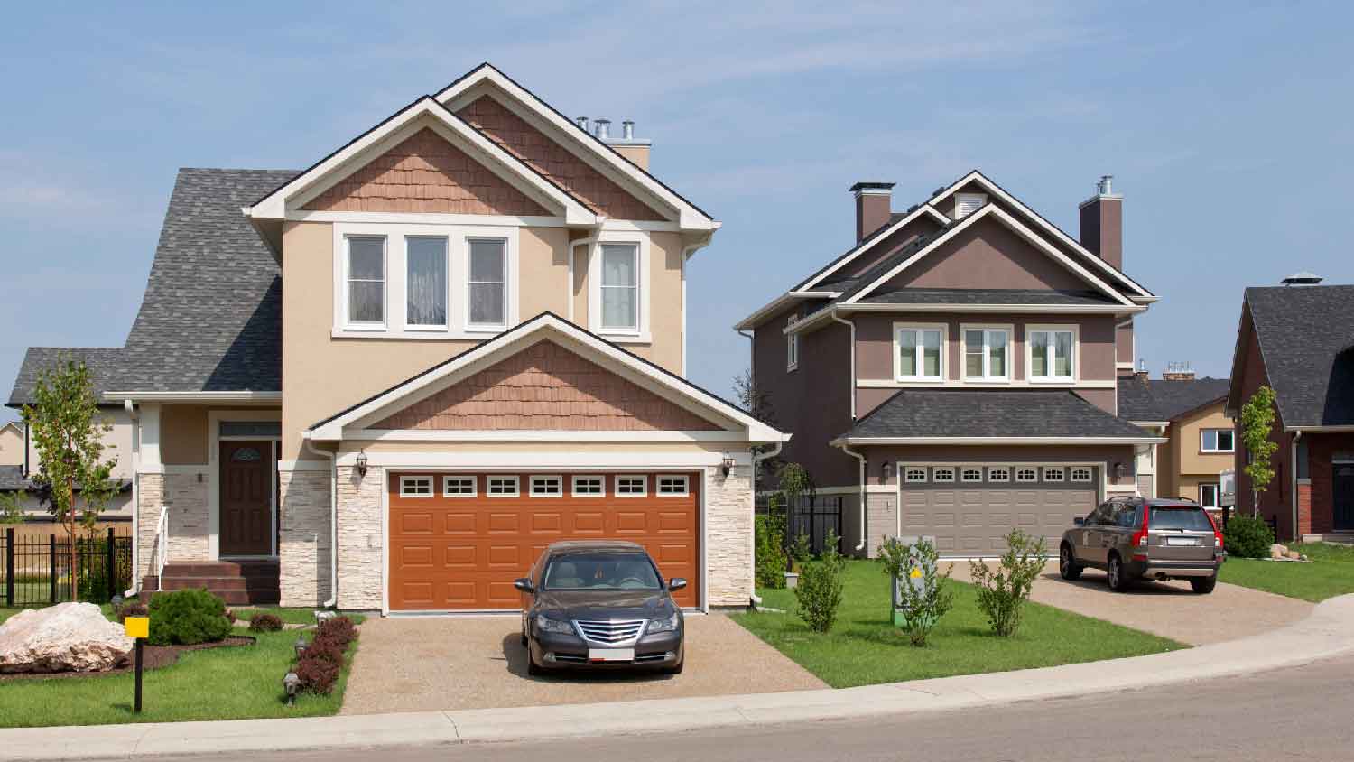 A suburban house with a car parked in the driveway