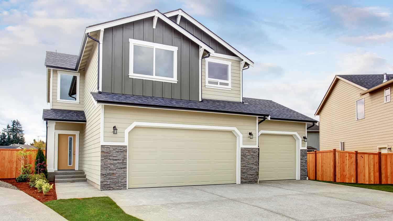 House exterior with automatic garage door and concrete driveway