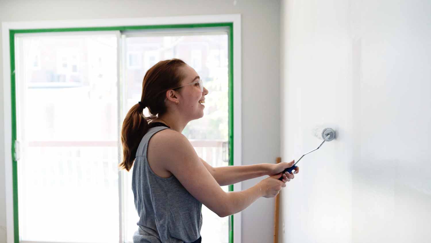 Woman painting living room