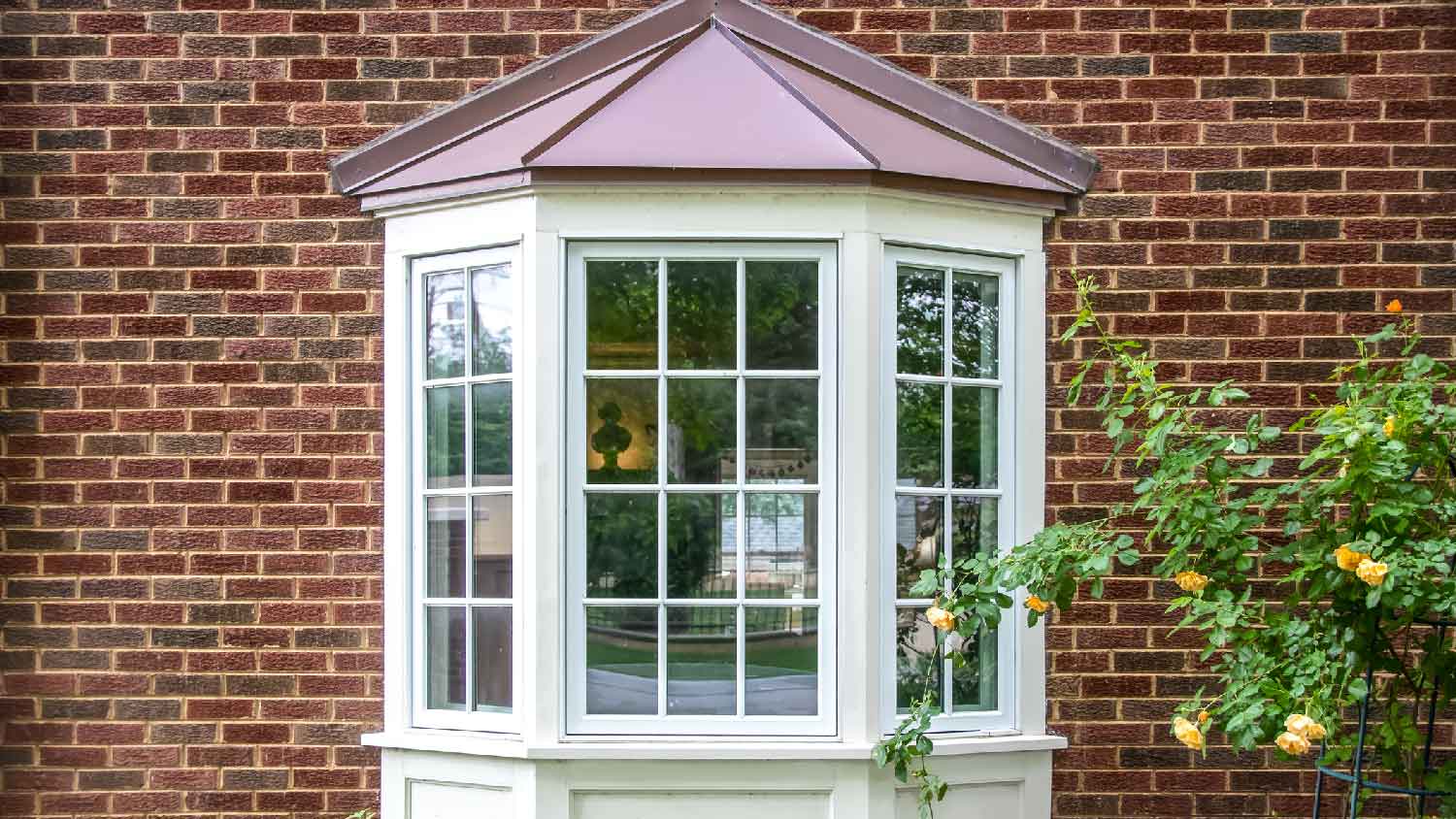 A bay window in a red brick house