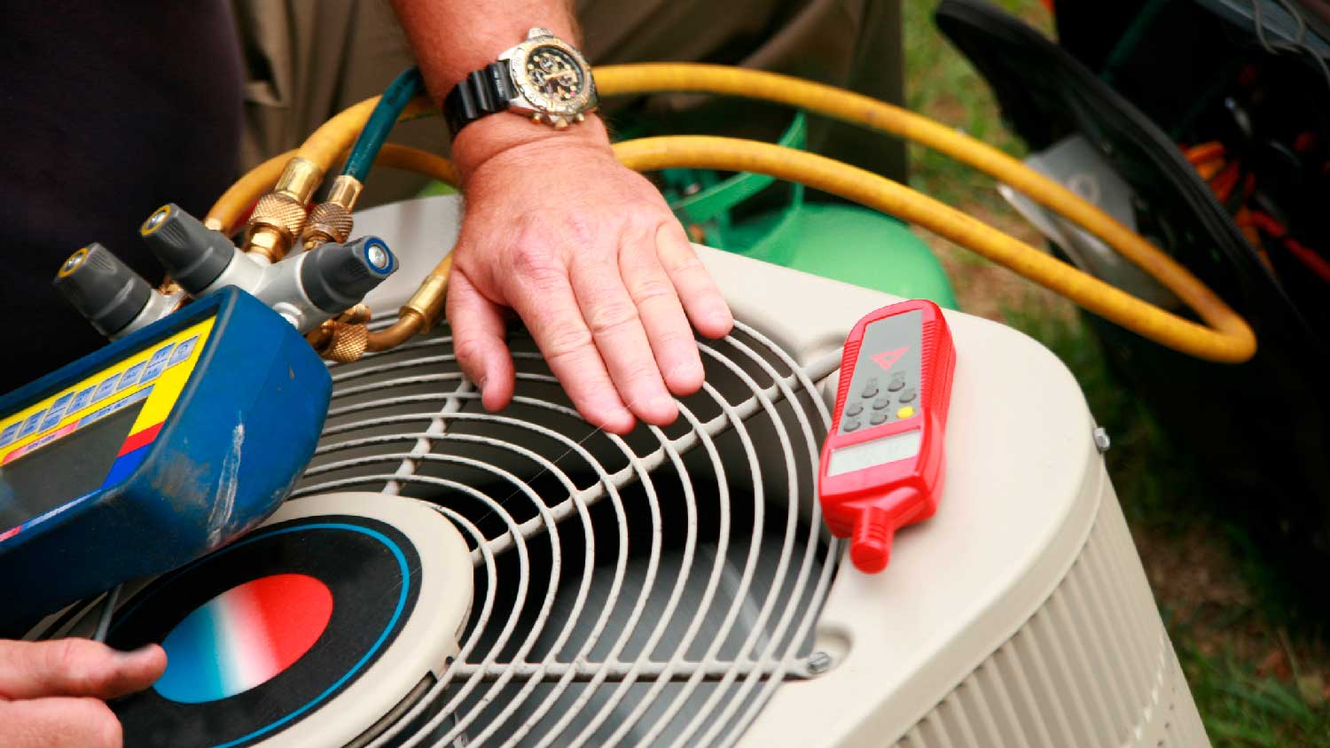 A man checking if the AC unit’s fan is working