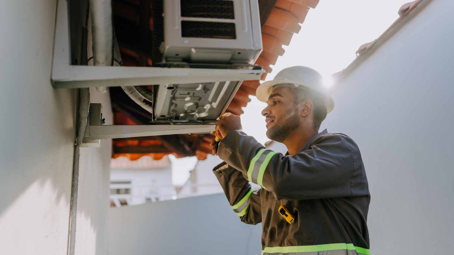Technician checking AC unit