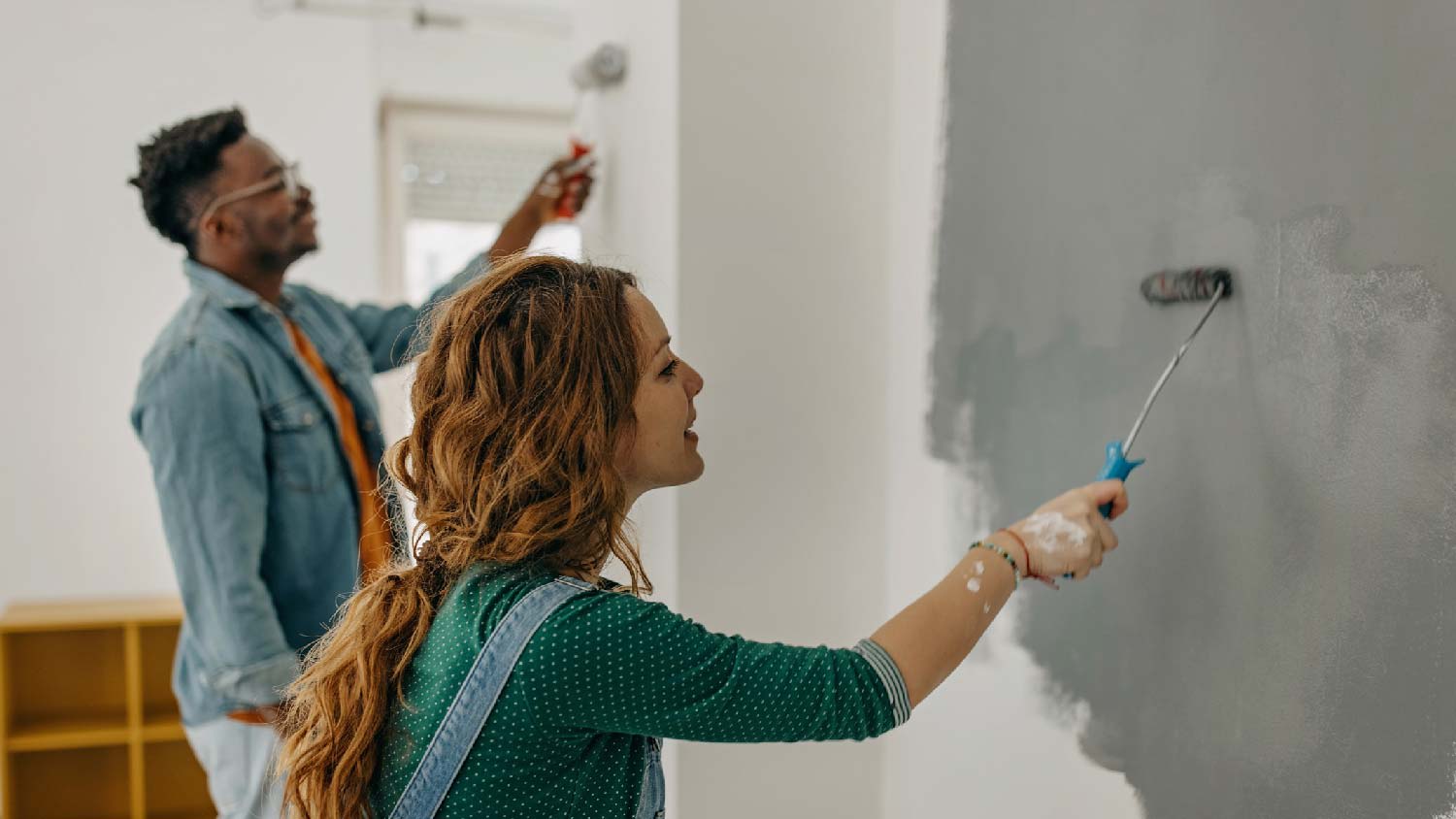 A couple painting a room