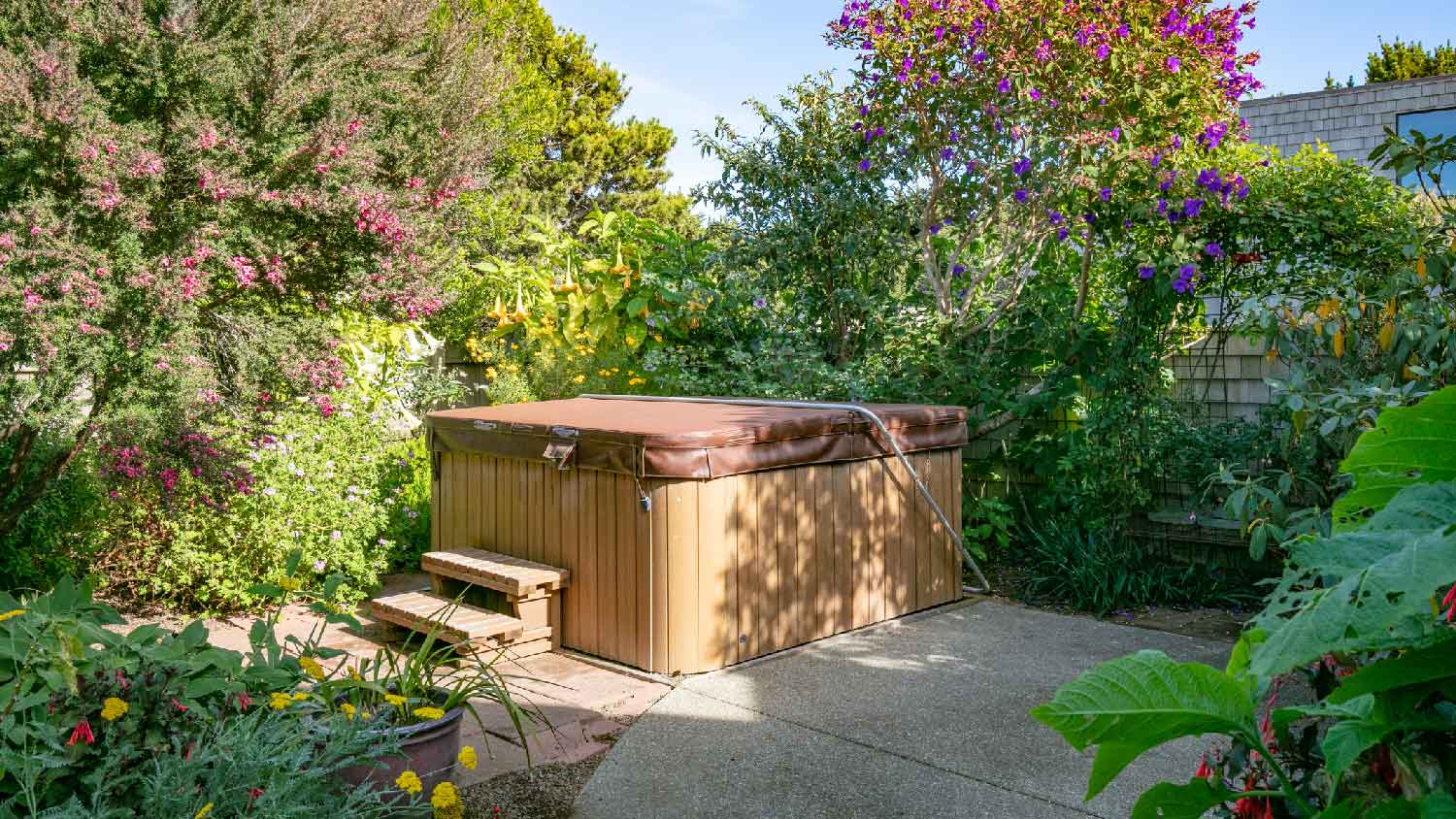 A covered hot tub in a garden