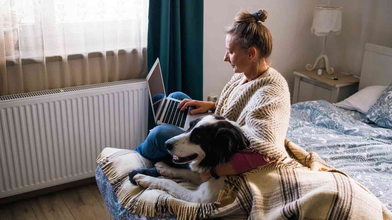 woman at home sitting by the heater