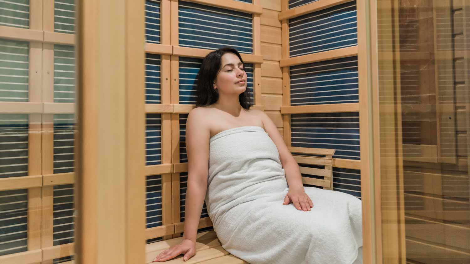 Woman relaxing in a sauna