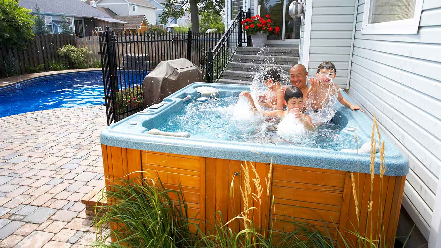 Father and children having fun in the hot tub