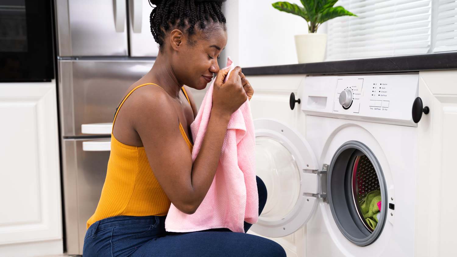Woman smells clothes coming out of dryer