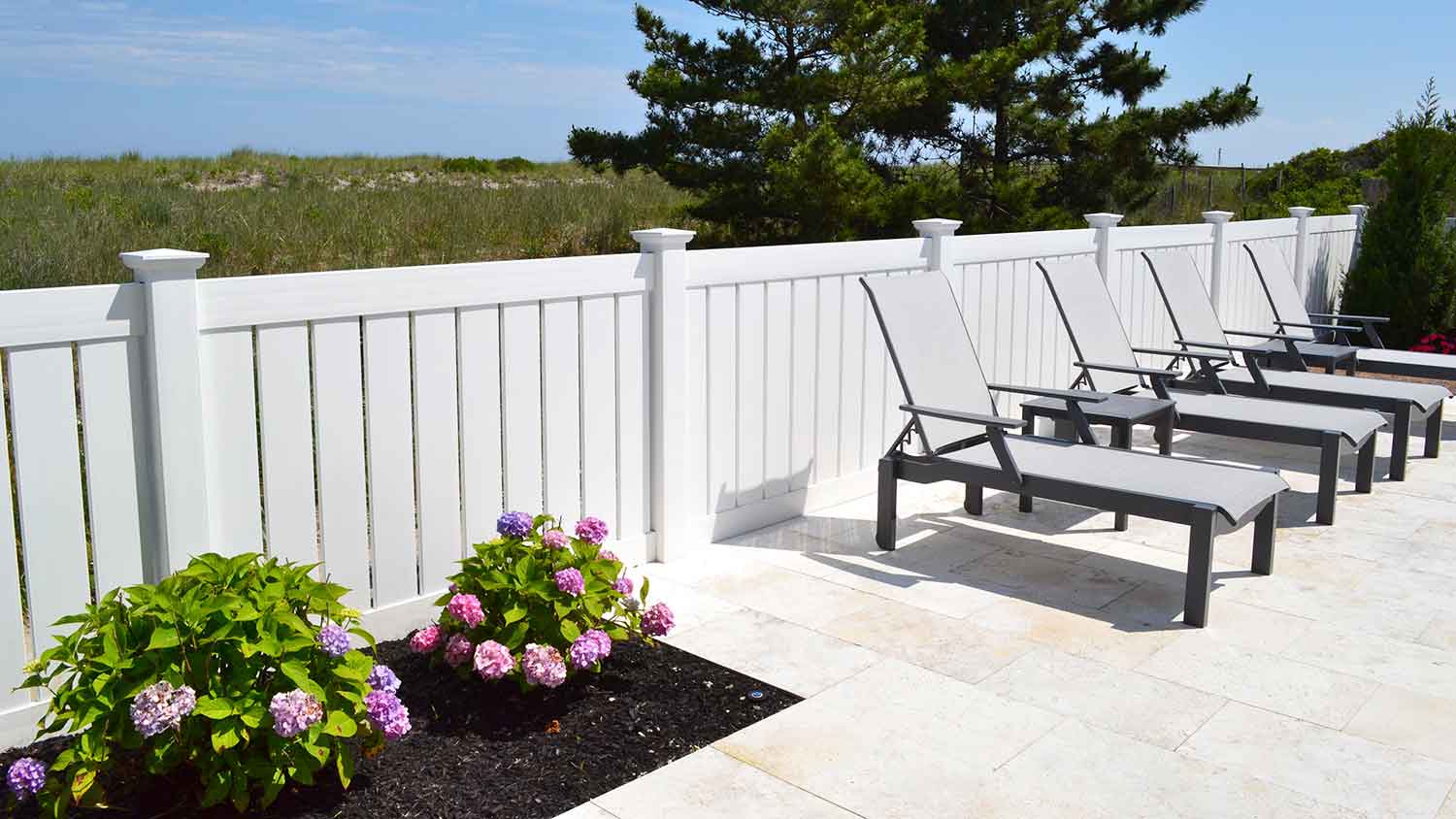 Pool area with white vinyl fence