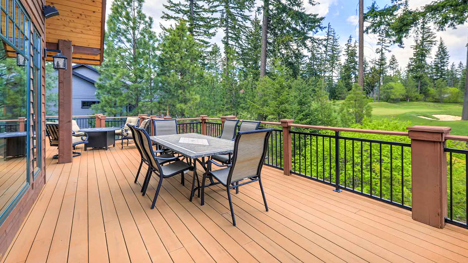 Large wooden deck with dining table and chairs