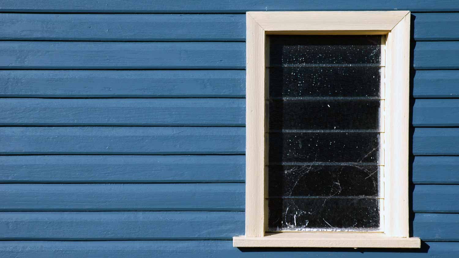 White window and blue siding