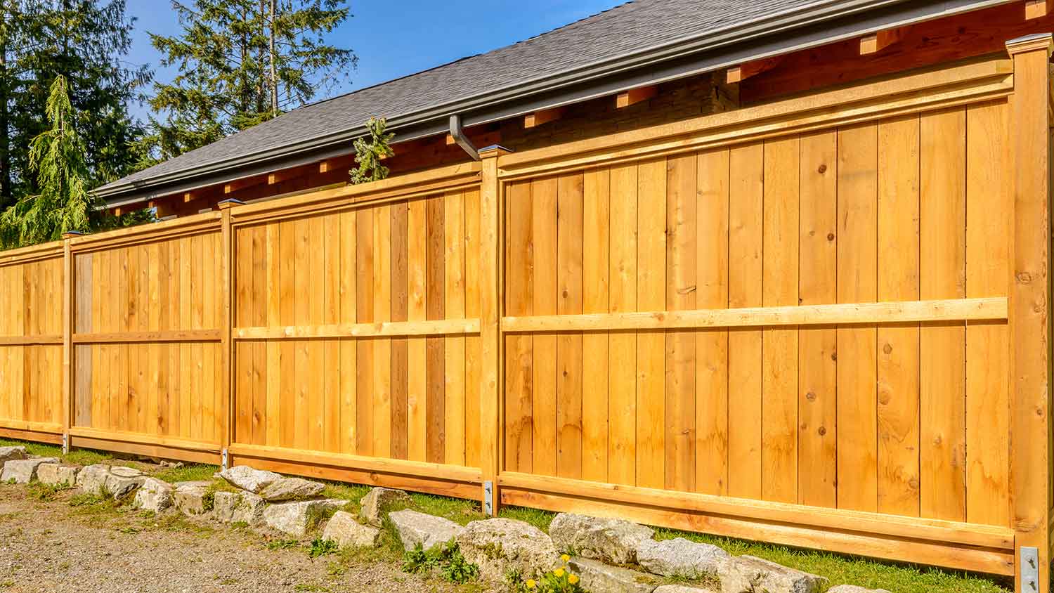 House exterior with a pressure-treated pine fence