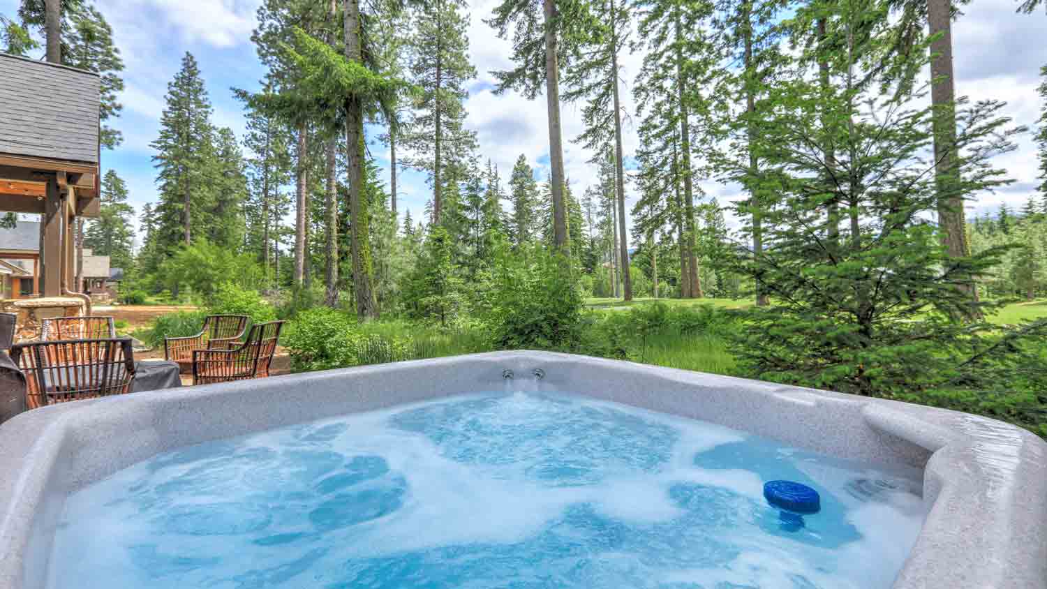 hot tub in the backyard with forest