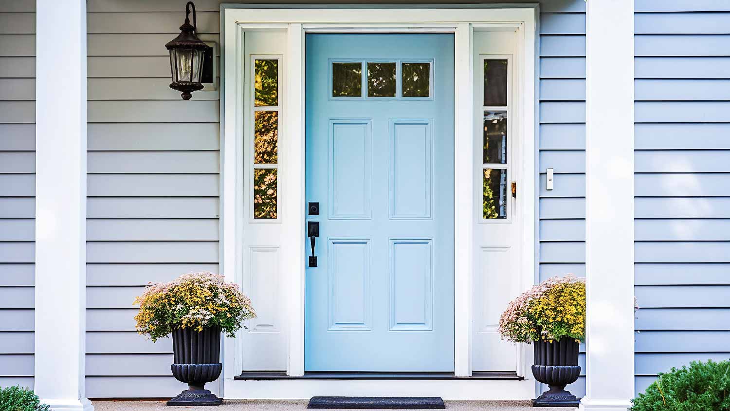 A blue front door with horizontal siding