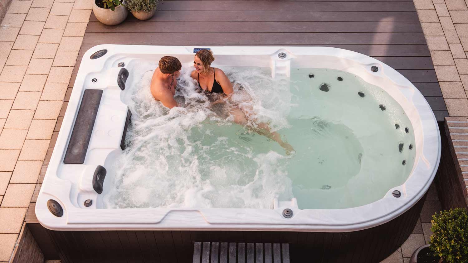 couple relaxing together in swim spa