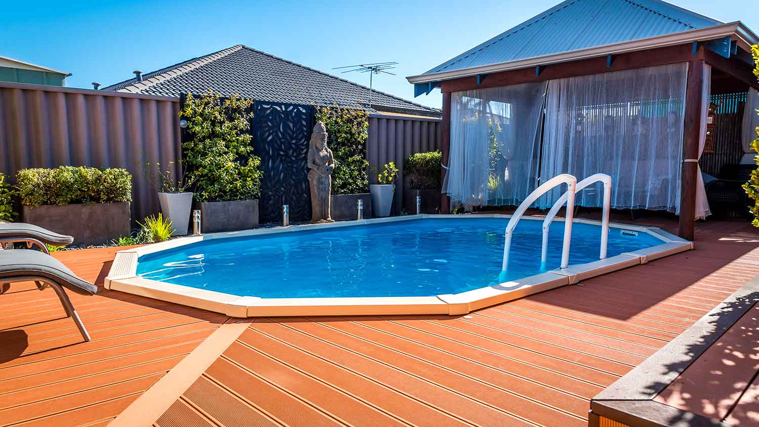 Above ground pool surrounded by decking